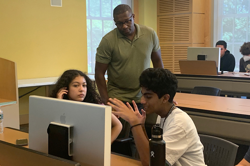 Prof. Wayne Edwards instructs students as they edit their news story. 