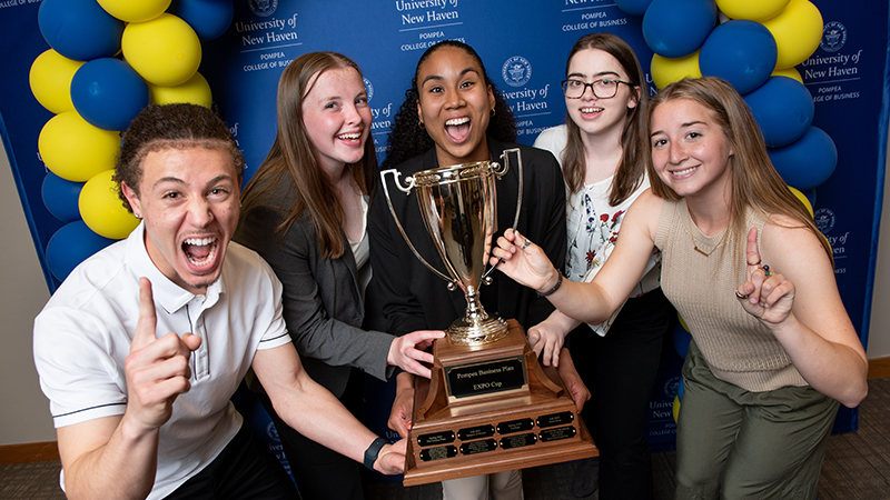 Winners pose with their trophy.