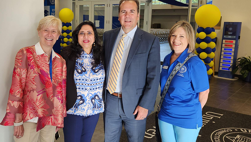 Ranjana Maitra '91 MBA and her fellow University staff members. Left to right: Cindy Gallatin, Ranjana Maitra, interim president Dr. Sheahon Zenger, and Anne Whitman.