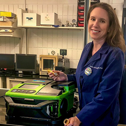 Brooke Kammrath, Ph.D., D-ABC, with a portable GC-MS. 