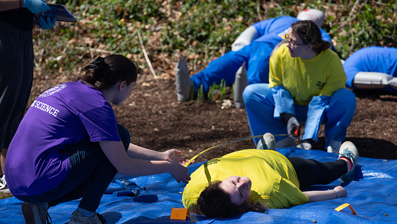 Students investigate a mock shooting.