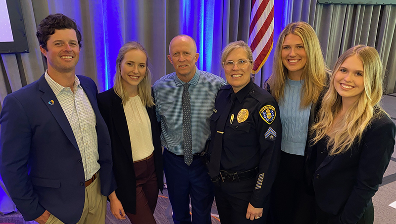 Lori Adams ’24 M.S. (in uniform) with her family. 