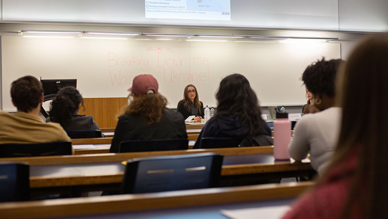 A clasroom setting, with Olena speaking in the front.