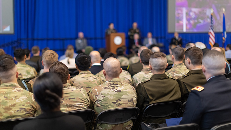 Veterans, seated in chairs, watching the ceremony unfold.