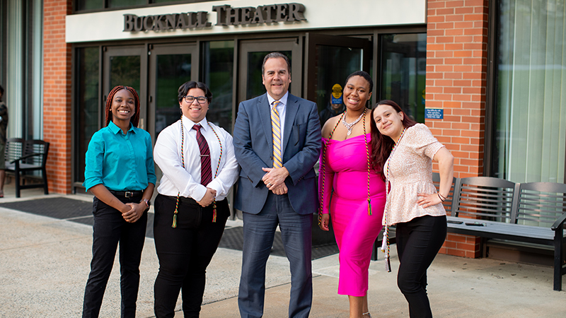 Interim president Sheahon Zenger, Ph.D., (center) celebrates with new grads. 