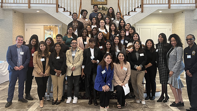 Karl Minges, Ph.D., MPH (far left), and students at a conference.