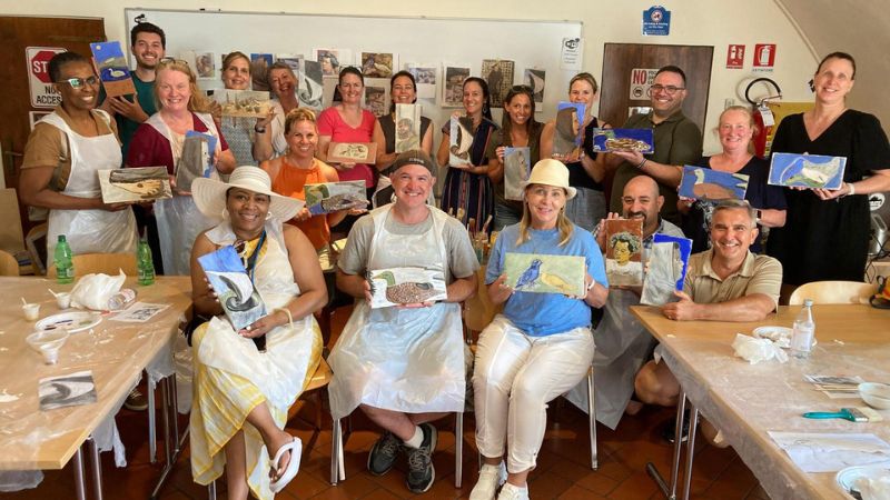 The school counselors display their creations after a fresco painting workshop.