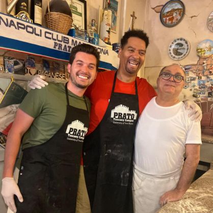 Josh Kealer (left), Phil Howard, and the owner of Pizland, a pizzeria a short walk from the Prato Campus.