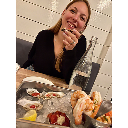 Samantha Zajac enjoys raw oysters on the Connecticut shoreline.