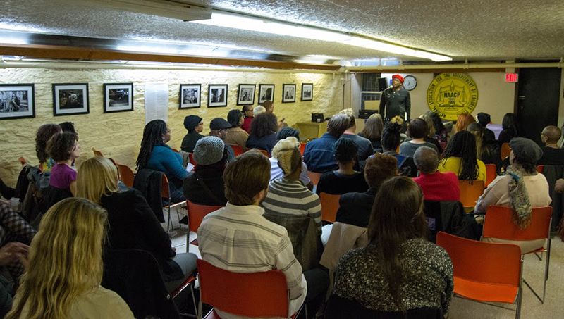 A packed crowd listens to Horton speak