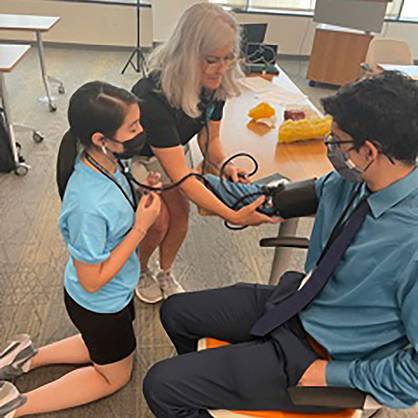 Student learning to take blood pressure.