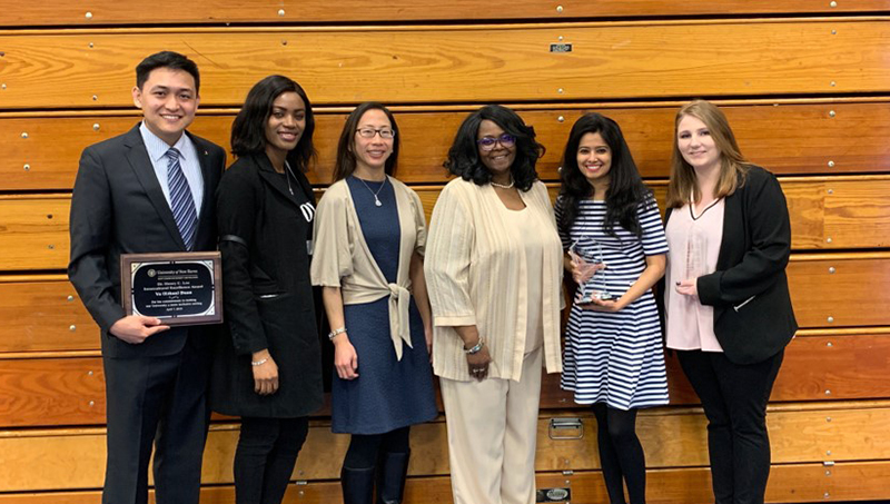 Linda Copney-Okeke poses for a photo along with her colleagues at an awards ceremony.