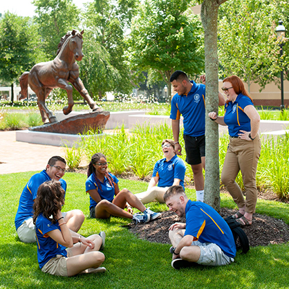 Orientation and transition leaders laughing outside.