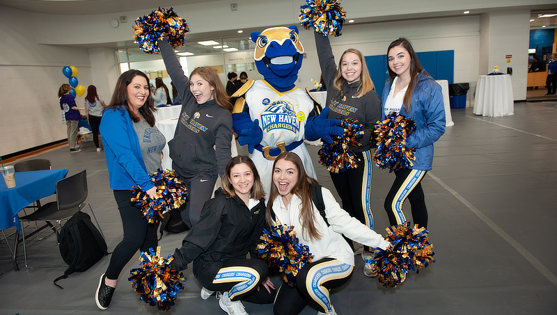 Charlie celebrates with members of the Chargers Dance Team.