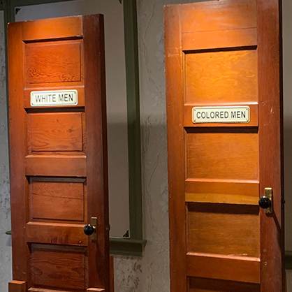 The signs on these bathroom doors enforced segregation in the Jim Crow south.  