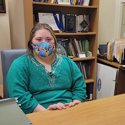 Image of a student helping Christine Delldonna with office work. 