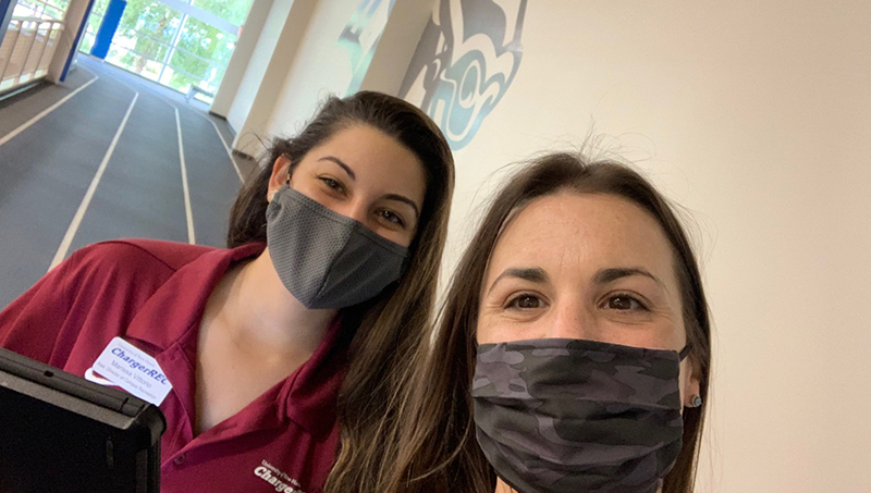 Image of Jessica Scibek and her colleague Marissa Vittorio holding a walking meeting on the indoor track at the Beckerman Recreation Center.