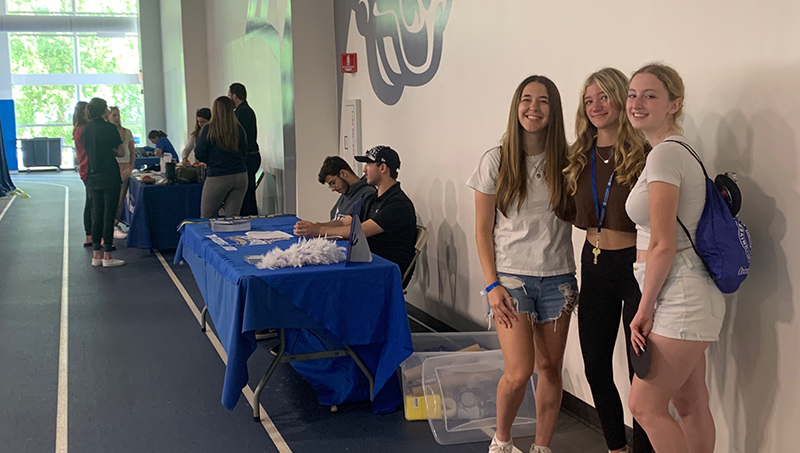 Lila Devlin-Perry ’26 (right), Molly Fitzpatrick ’26 (center), and Samantha Villa ’26 at the resource fair.