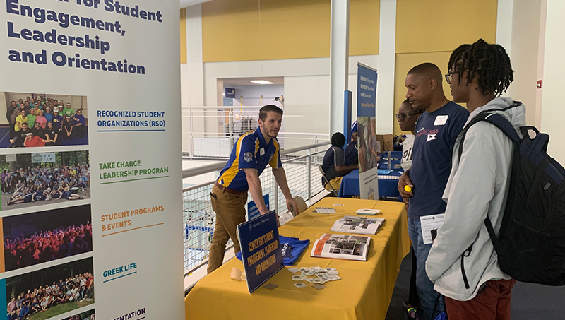 Michael Chung ’26 and his parents visited the Center for Student Engagement, Leadership, and Orientation table at the resource fair. 