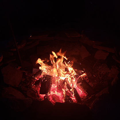 Beatrice Glaviano ’26 relaxes by a fire.