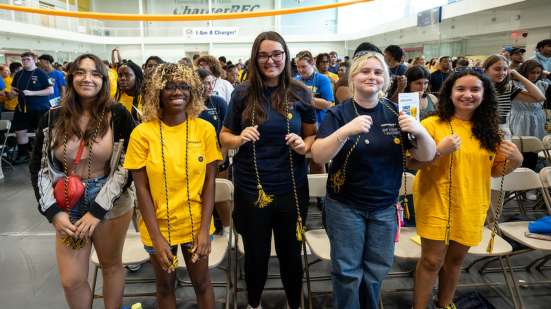 Members of the Class of 2028 put on a Charger cord