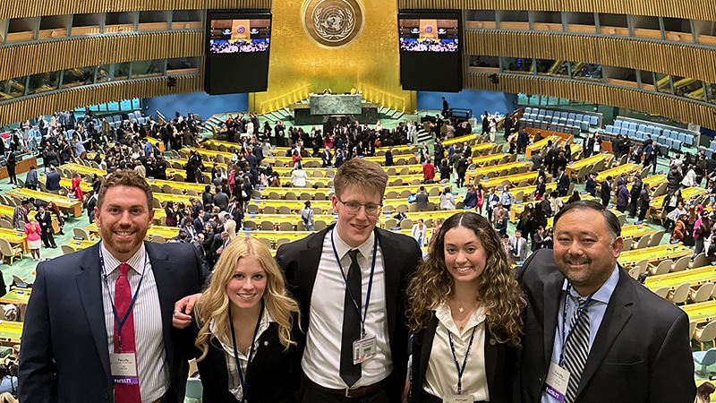 Dr. Chris Haynes (right) with students at the conference. 